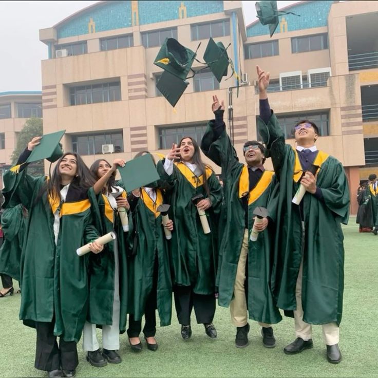 Graduating students celebrating and throwing their caps in the air.